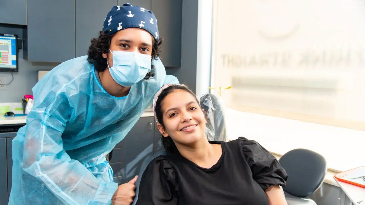 A team member and patient smiling
