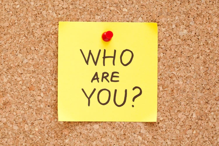 The phrase "Who are you?" on a sticky note